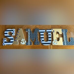 Nautical letters spelling “SAMUEL”